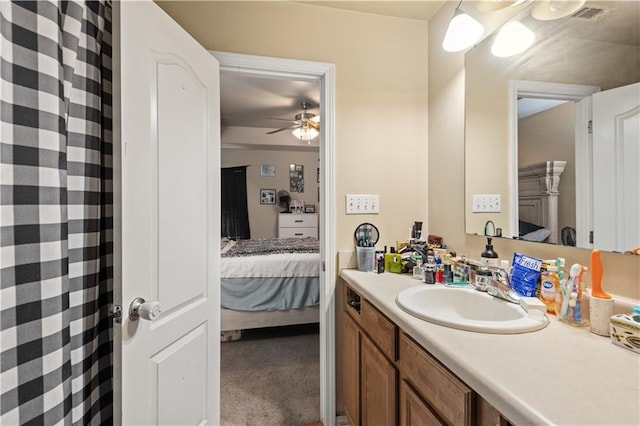 bathroom featuring visible vents, ceiling fan, vanity, and ensuite bath