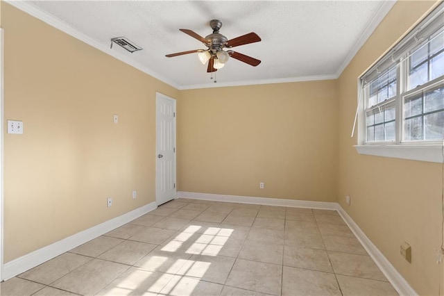 spare room with light tile patterned floors, ceiling fan, visible vents, baseboards, and ornamental molding