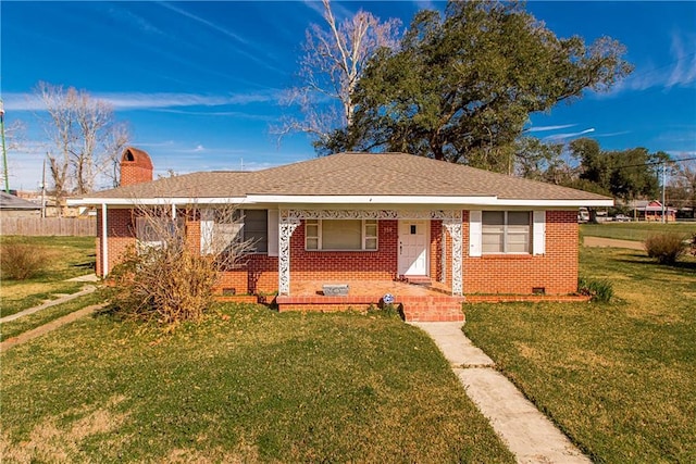 view of front of house with brick siding, a chimney, roof with shingles, crawl space, and a front yard