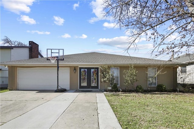 single story home with a garage, stucco siding, a front lawn, and french doors