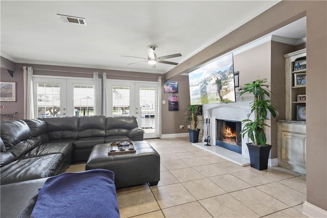 305 Eden Isles Dr, Slidell, LA 70458 - living area with ceiling fan, a lit fireplace, crown molding, light tile patterned flooring, and healthy amount of natural light