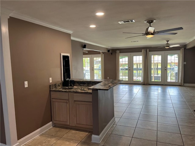 305 Eden Isles Dr, Slidell, LA 70458 - kitchen featuring french doors, crown molding, a peninsula, plenty of natural light, and open floor plan