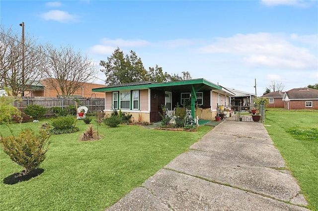 ranch-style house with driveway, a front lawn, and fence