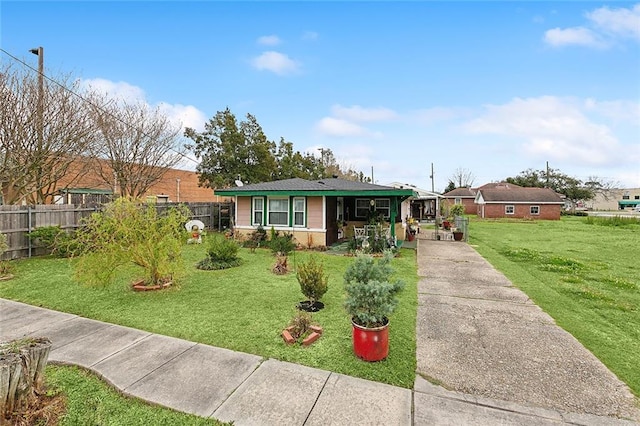 single story home featuring a front lawn and fence