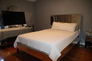 bedroom with dark wood finished floors