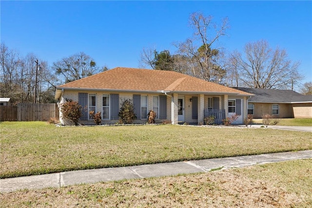 ranch-style home featuring a porch, fence, and a front lawn