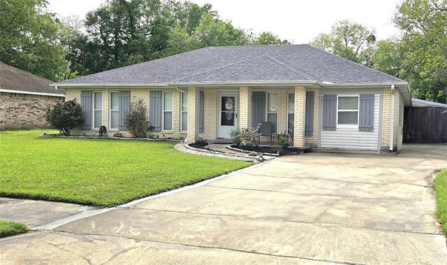 1433 Meadowlawn St, Slidell, LA 70460 - single story home with a porch, brick siding, concrete driveway, and a front lawn