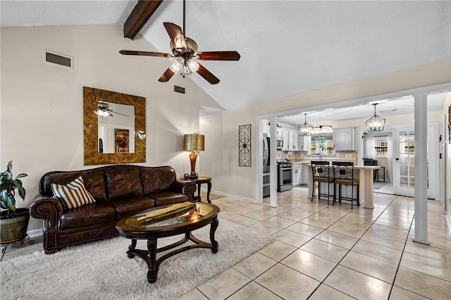 living area with visible vents, ceiling fan, lofted ceiling with beams, and light tile patterned flooring