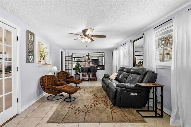 1433 Meadowlawn St, Slidell, LA 70460 - living room featuring baseboards, a textured ceiling, tile patterned floors, and a ceiling fan