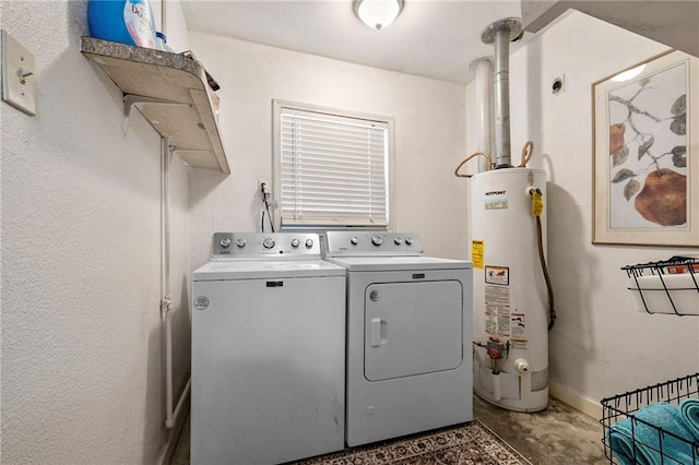 laundry room featuring laundry area, washing machine and dryer, water heater, and baseboards