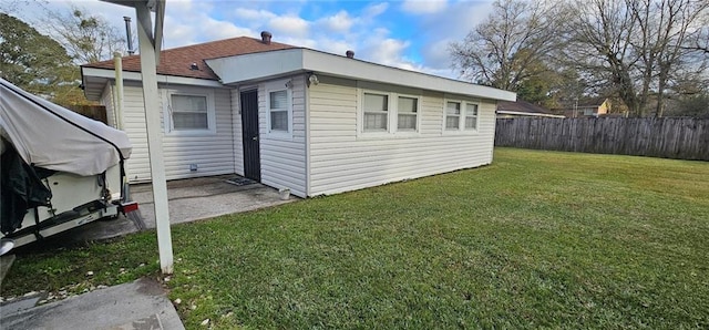 back of house with a yard and fence