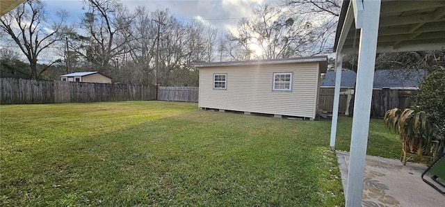 view of yard with a fenced backyard, an outdoor structure, and a shed