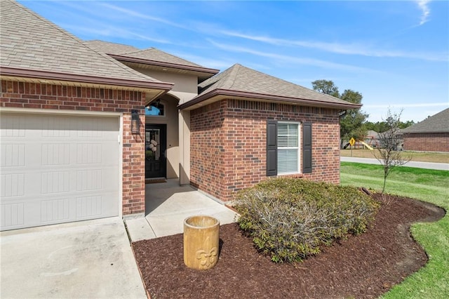 view of front of home with a garage, brick siding, and a shingled roof