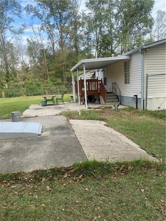 exterior space featuring a lawn, a patio, and fence