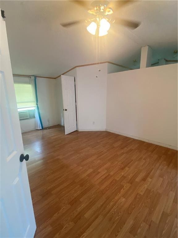 empty room with ceiling fan and wood finished floors