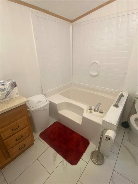 bathroom with marble finish floor, vanity, and toilet