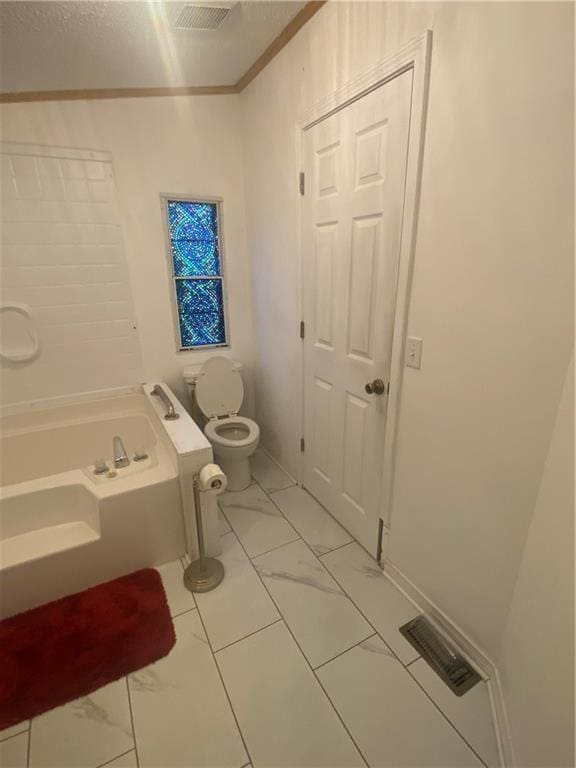 full bath featuring a bath, marble finish floor, toilet, and visible vents