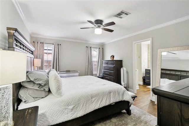 bedroom with crown molding, multiple windows, visible vents, and light wood-style floors