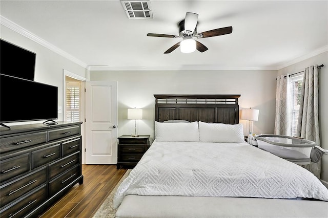 bedroom with ornamental molding, visible vents, dark wood finished floors, and ceiling fan