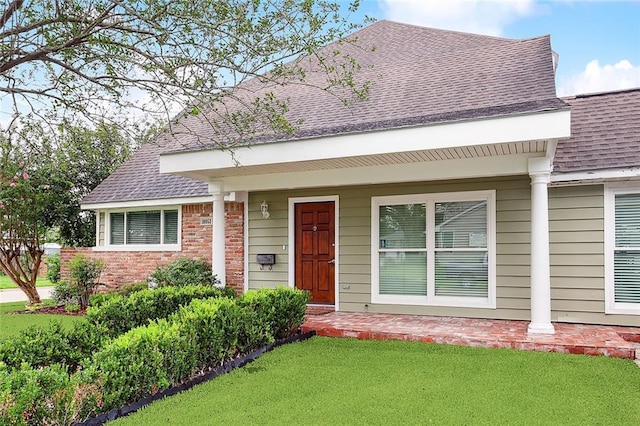 10053 Joel Ave, River Ridge, LA 70123 - view of front of home with brick siding, a front yard, and roof with shingles