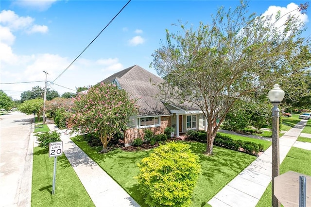 10053 Joel Ave, River Ridge, LA 70123 - view of front facade featuring a front yard and brick siding
