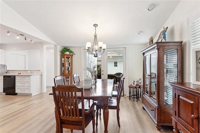 10053 Joel Ave, River Ridge, LA 70123 - dining area with light wood-style flooring, vaulted ceiling, and an inviting chandelier