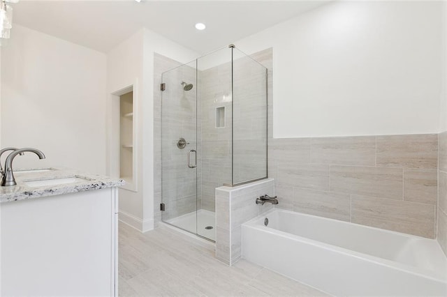 10053 Joel Ave, River Ridge, LA 70123 - bathroom with a garden tub, a sink, and a stall shower