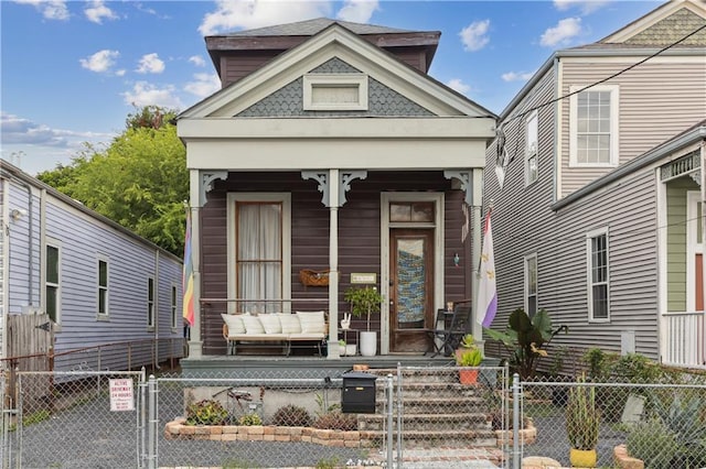 shotgun-style home with a fenced front yard