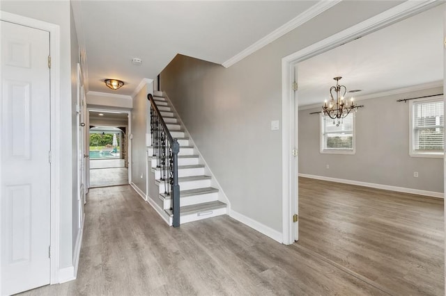 stairs featuring baseboards, wood finished floors, a wealth of natural light, and crown molding