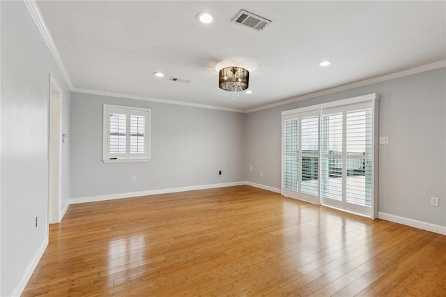 empty room with plenty of natural light, visible vents, and light wood-style floors