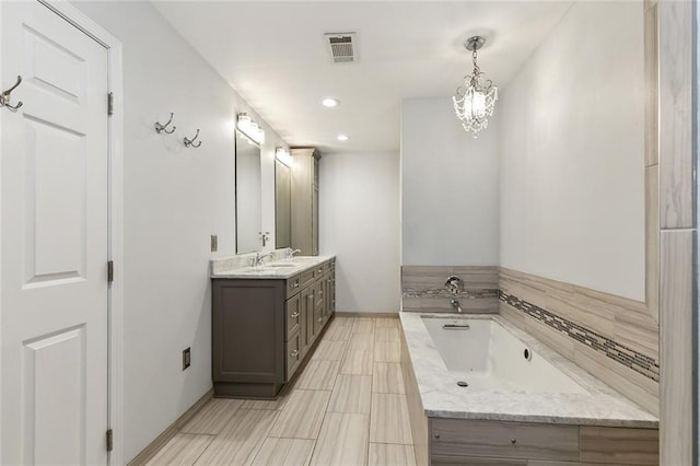 bathroom featuring double vanity, baseboards, visible vents, a bath, and a sink