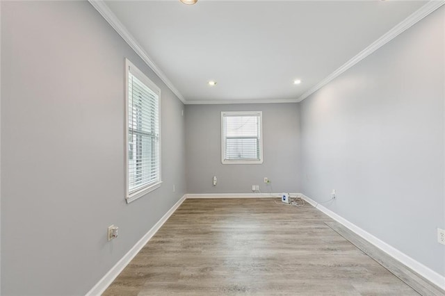 spare room with light wood finished floors, recessed lighting, baseboards, and ornamental molding