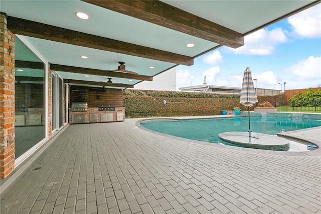 view of pool featuring exterior kitchen, a fenced in pool, a fenced backyard, and a patio