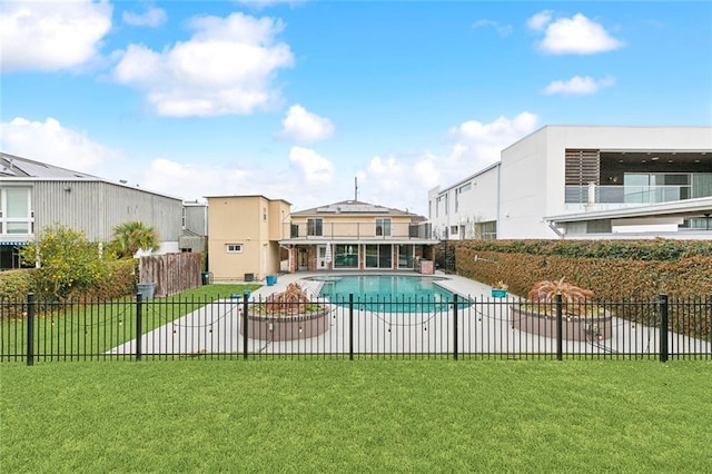 pool with a residential view, fence, and a yard