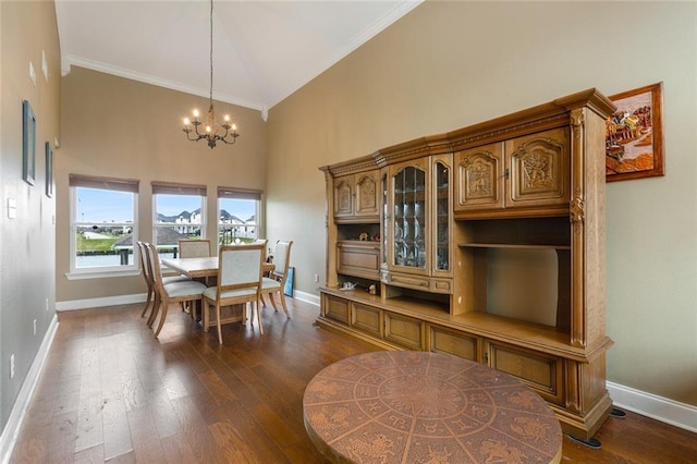 dining room with baseboards, a chandelier, and dark wood finished floors