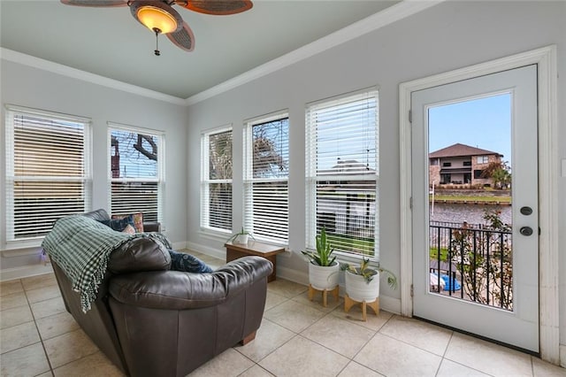 interior space with a water view, crown molding, baseboards, and light tile patterned floors