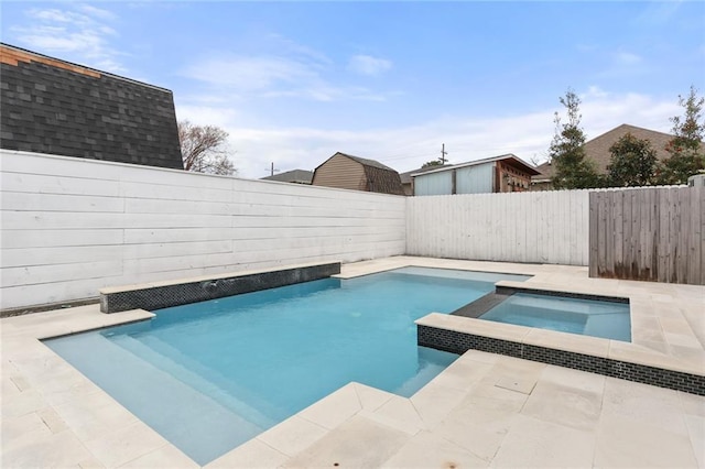view of swimming pool with an in ground hot tub, a fenced backyard, and a fenced in pool