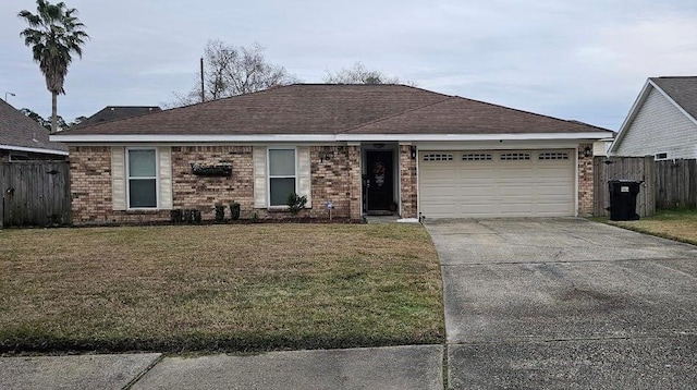 ranch-style home featuring a garage, a front yard, driveway, and a shingled roof