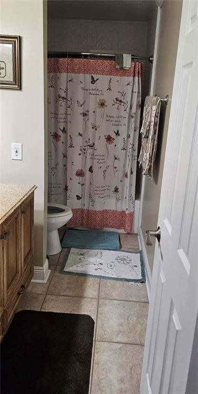 full bathroom with toilet, a shower with shower curtain, vanity, and tile patterned floors