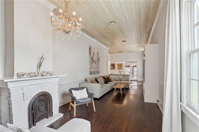 717 Port St, New Orleans, LA 70117 - living room with hardwood / wood-style floors, wooden ceiling, crown molding, a brick fireplace, and a notable chandelier