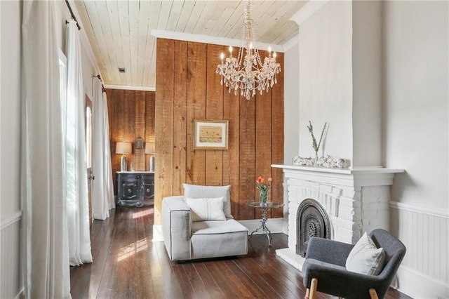 717 Port St, New Orleans, LA 70117 - living area featuring wood walls, wooden ceiling, dark wood-style flooring, and an inviting chandelier