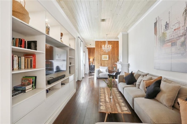 717 Port St, New Orleans, LA 70117 - living room with dark wood-style flooring, an inviting chandelier, wood walls, crown molding, and wooden ceiling