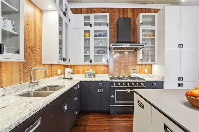 717 Port St, New Orleans, LA 70117 - kitchen with a sink, extractor fan, white cabinetry, and range with two ovens