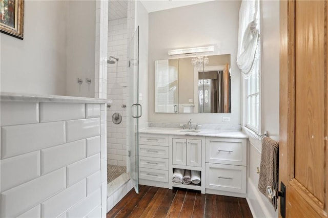 717 Port St, New Orleans, LA 70117 - full bathroom featuring wood finished floors, vanity, and a stall shower