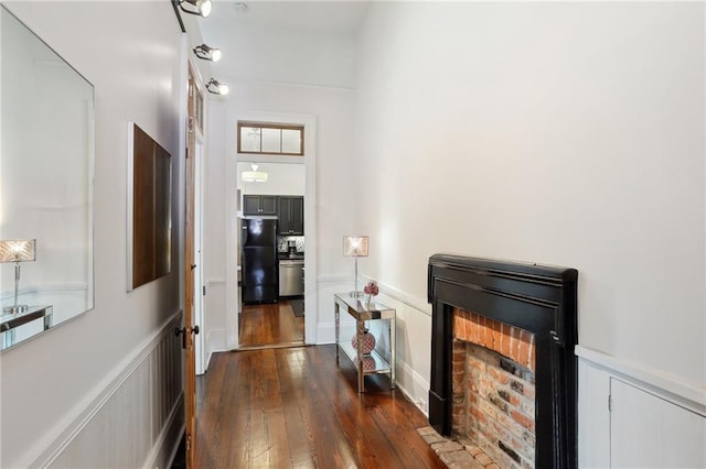 717 Port St, New Orleans, LA 70117 - corridor featuring wainscoting, a decorative wall, and dark wood finished floors