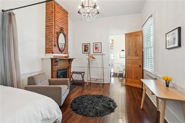 717 Port St, New Orleans, LA 70117 - bedroom featuring hardwood / wood-style flooring, a fireplace, and a chandelier