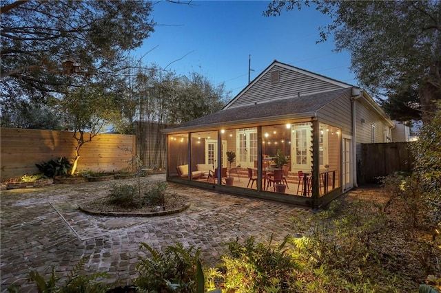 717 Port St, New Orleans, LA 70117 - rear view of property with a fenced backyard, a deck, a patio, and french doors