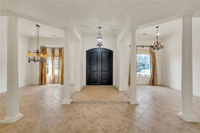 entrance foyer featuring light tile patterned floors, an inviting chandelier, and ornate columns