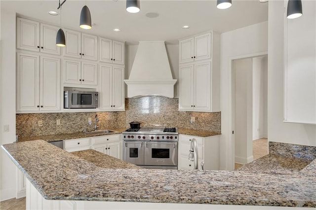 kitchen with stainless steel appliances, white cabinets, custom exhaust hood, light stone countertops, and pendant lighting