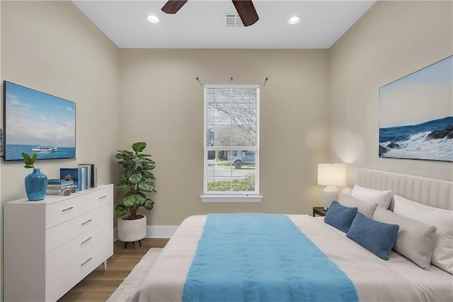 bedroom with dark wood-style floors, ceiling fan, visible vents, and recessed lighting